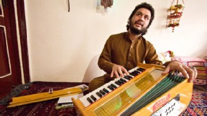 PHOTO: 23-year old Naweed Forugh, a former winner of Afghanistan's version of American Idol, plays the harmonia, a traditional Afghan musical instrument, in his living room. After nearly losing his life to an unknown gunman, Forugh is too afraid to leave 