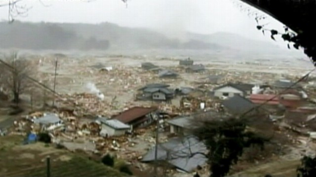 VIDEO: Onlookers scream as tsunami rips through town of Minamisanriku.