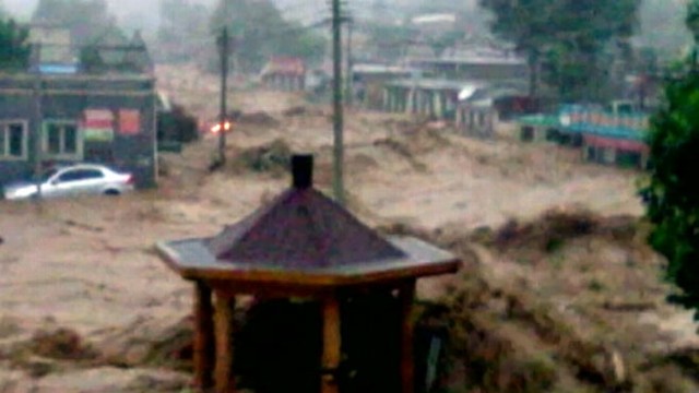 VIDEO: Buildings and cars are overtaken by heavy floodwaters tearing through the city of Beijing.