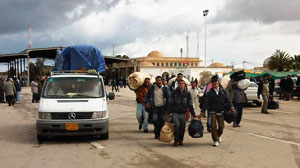 PHOTO A constant stream of people at the Raj Ajdir boarding crossing between Libya and Tunisia as refugees flee Libya, Feb. 23, 2011.