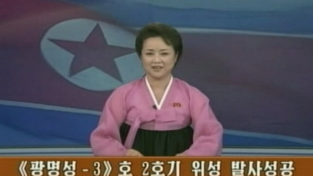 PHOTO: An unnamed television presenter announces the successful launch of an n intercontinental ballistic missile.