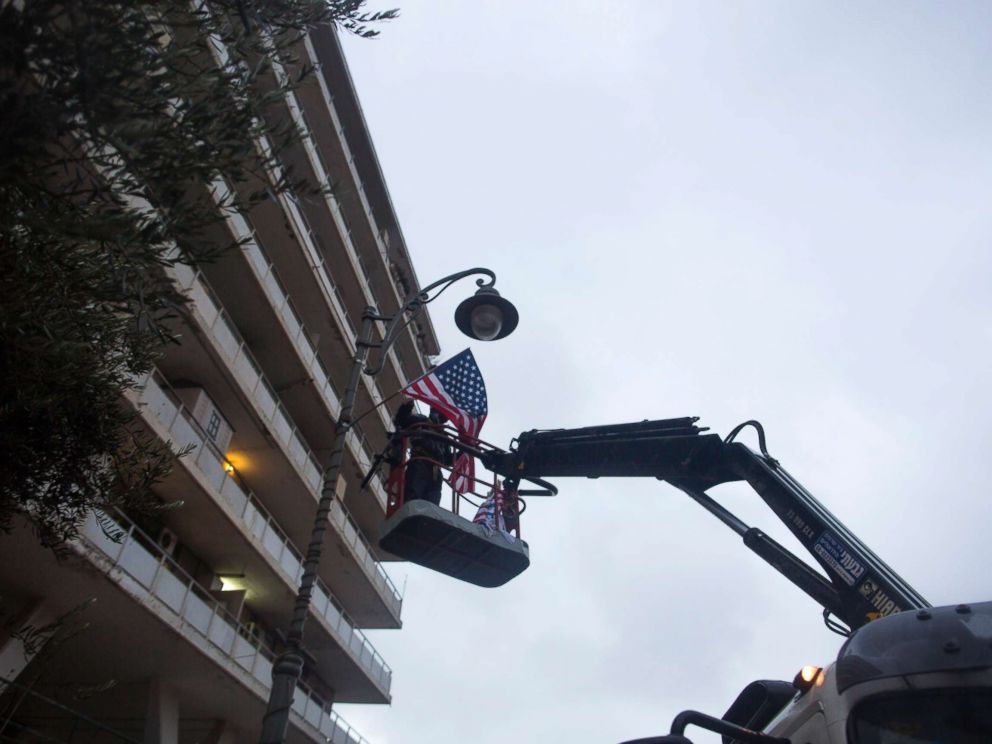 PHOTO: A municipal employee hangs an American flag next to the U.S. Consulate on Dec. 6, 2017 in Jerusalem, Israel.