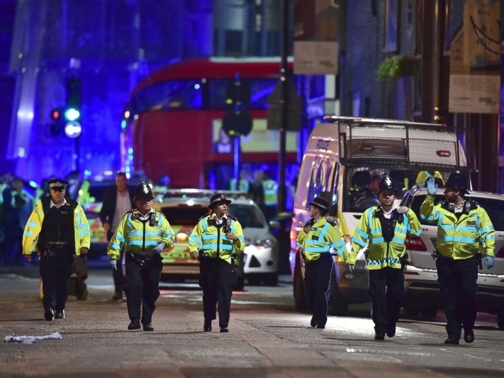 PHOTO: Police officers gather on Borough High Street as police deal with an incident on London Bridge in London, Saturday, June 3, 2017.