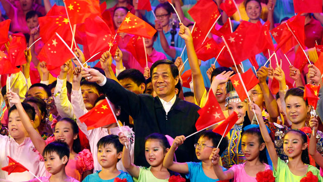 PHOTO: In this photo taken on Sept. 29, 2011, Bo Xilai, party boss of Chongqing, center, and others wave Chinese flags during a gathering to promote the singing of  "red songs" in southwest China's Chongqing Municipality.