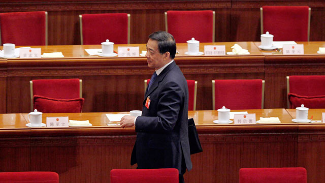 PHOTO: Chongqing party secretary Bo Xilai walks past deserted seats after a plenary session of the National People's Congress in Beijing, China, March 9, 2012.