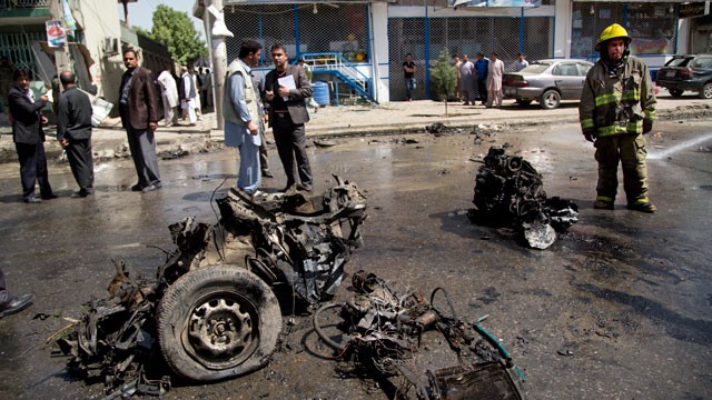 PHOTO: An Afghan fireman stands next to the debris of a car at the scene where a suicide car bomber attacked a NATO convoy in Kabul, Afghanistan, May 16, 2013.
