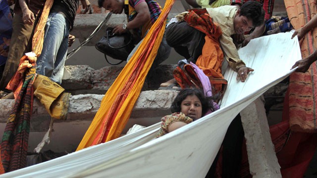 PHOTO: Rescue workers use pieces of clothes to bring down a survivor after an eight-story building housing several garment factories collapsed in Savar, near Dhaka, Bangladesh, Wednesday, April 24, 2013.