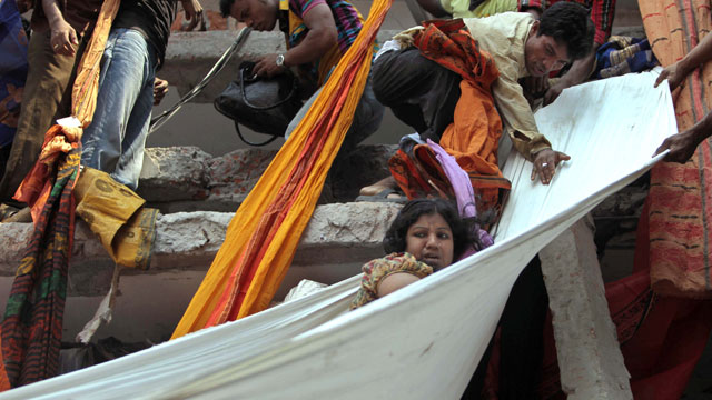 PHOTO: Rescue workers use pieces of clothes to bring down a survivor after an eight-story building housing several garment factories collapsed in Savar, near Dhaka, Bangladesh, Wednesday, April 24, 2013.