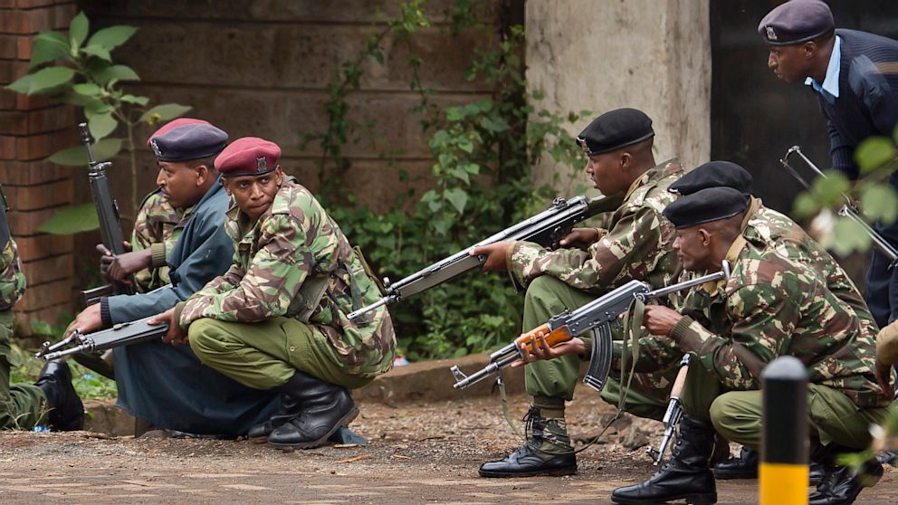 PHOTO: Armed police from the General Service Unit take cover behind a wall during a bout of gunfire, outside the Westgate Mall in Nairobi, Kenya Monday, Sept. 23, 2013.