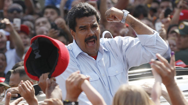 PHOTO: Venezuelas interim President Nicolas Maduro gestures to supporters as he leaves a polling station after voting in the presidential election in Caracas, Venezuela, Sunday, April 14, 2013.
