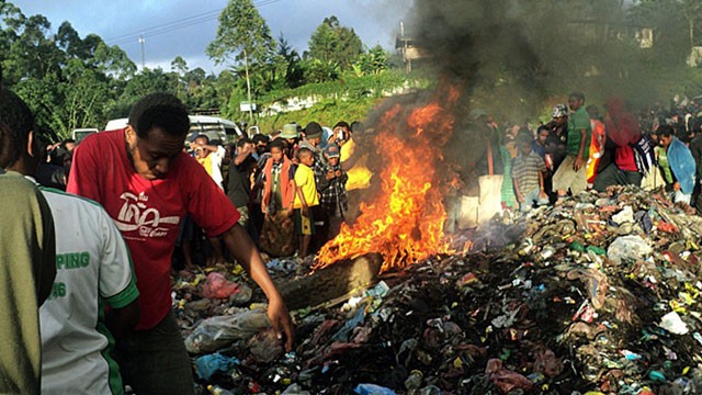 PHOTO: Bystanders watch as a woman accused of witchcraft is burned alive in the Western Highlands provincial capital of Mount Hagen in Papua New Guinea, Feb. 6 2013.