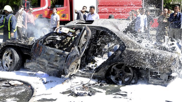 PHOTO: This photo released by the Syrian official news agency SANA, shows Syrian fire fighters extinguishing burning cars after a car bomb exploded in the capitals western neighborhood of Mazzeh, in Damascus, Syria, Monday, April. 29, 2013.