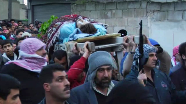 PHOTO: This image taken from video filmed by an independent cameraman and made available Tuesday Feb. 7, 2012 show mourners gathered around a funeral procession in Homs, Syria.