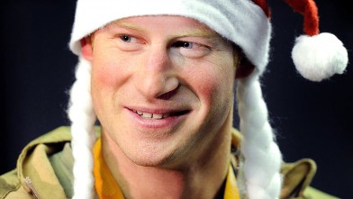 PHOTO: Prince Harry wears a Santa hat as he shows to a TV crew his sleeping area at the VHR (very high readiness) tent close to the flight-line, from Camp Bastion southern Afghanistan, Dec. 12 2012.