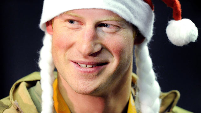 PHOTO: Prince Harry wears a Santa hat as he shows to a TV crew his sleeping area at the VHR (very high readiness) tent close to the flight-line, from Camp Bastion southern Afghanistan, Dec. 12 2012.