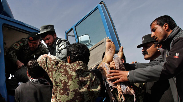 PHOTO: Afghan Army soldiers remove a dead passenger from a truck after U.S. forces shot at an Afghan truck, killing two passengers and injuring another on the road between Kabul and Bagram, Afghanistan, March 11, 2013.