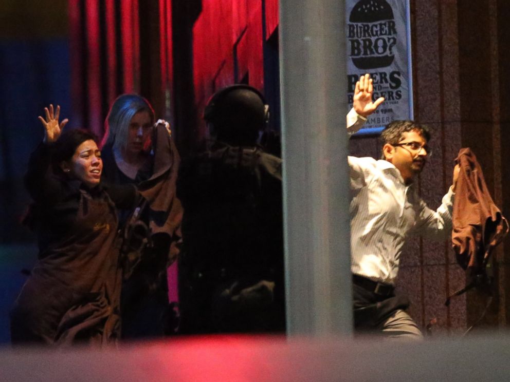 PHOTO: Hostages run towards armed tactical response police as they run to freedom from a cafe under siege at Martin Place in the central business district of Sydney, Australia, Dec. 16, 2014.