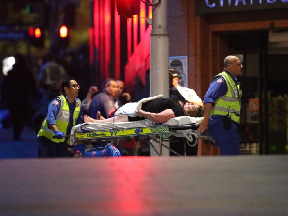 PHOTO: A injured hostage is wheeled to an ambulance after shots were fired during a cafe siege at Martin Place in the central business district of Sydney, Australia, Dec. 16, 2014.