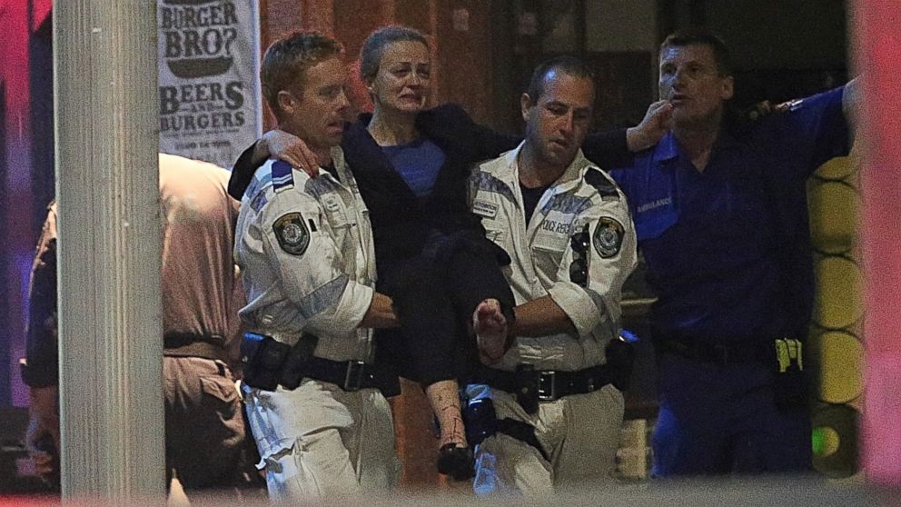 PHOTO: A injured hostage is carried to an ambulance after shots were fired during a cafe siege at Martin Place in the central business district of Sydney, Australia, Dec. 16, 2014. 