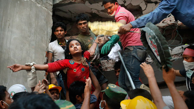 PHOTO: A Bangladeshi woman survivor is lifted out of the rubble by rescuers on April 25, 2013 at the site of a building that collapsed on April 24, 2013 in Savar, near Dhaka, Bangladesh.