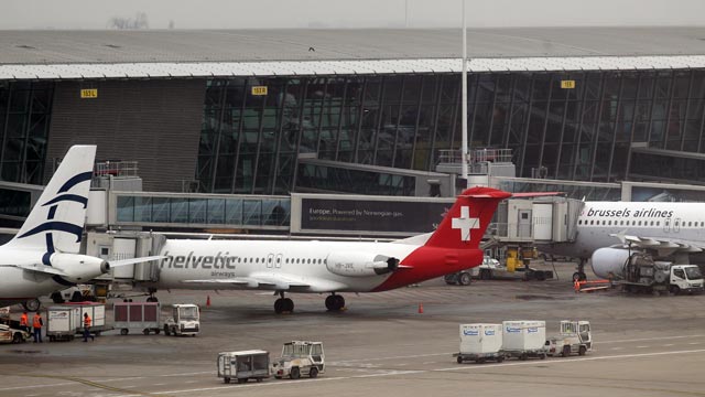 PHOTO: Baggage carts make their way past a Helvetic Airways aircraft from which millions of dollars worth of diamonds were stolen on the tarmac of Brussels international airport, Feb. 19, 2013.