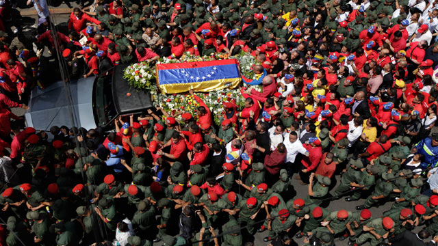 PHOTO: The flag-draped coffin containing the body of Venezuelas late President Hugo Chavez is taken from the hospital where he died, to a military academy where it will remain until his funeral in Caracas, Venezuela, March 6, 2013.