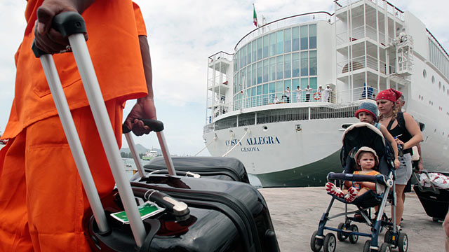 PHOTO: Passengers of the Costa Allegra cruise ship wait to board on a ferry at Victorias harbor, Seychelles Island, March 1, 2012.