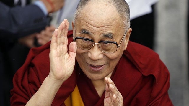 PHOTO: Exiled Tibetan spiritual leader the Dalai Lama greets people during a visit to Londonderry, Northern Ireland, April 18, 2013.