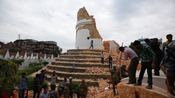 Volunteers work to remove debris at the historic Dharahara tower, a city landmark, after an earthquake in Kathmandu, Nepal, April 25, 2015. 
