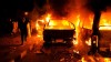 PHOTO: A riot policeman passes burning vehicles during clashes outside the U.S. embassy in Cairo, Egypt, early Thursday, Sept. 13, 2012, as part of widespread anger across the Muslim world about a film ridiculing Islam's Prophet Muhammad.