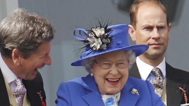 PHOTO: Britains Queen Elizabeth II, center, reacts as she looks out from the balcony at the end of the Epsom Derby horse race at Epsom racecourse England at the start of a four-day Diamond Jubilee celebration to mark the 60th anniversary of Queen Elizabe