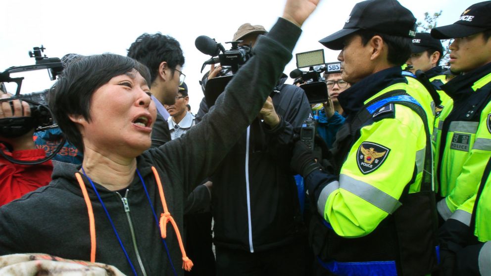 PHOTO: A weeping relative of a missing passenger aboard the sunken ferry Sewol shouts as she tries to march toward the presidential house to protest the governments rescue operation in Jindo, South Korea, Sunday, April 20, 2014.