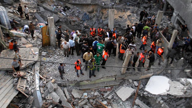 PHOTO: Palestinians stand in the rubble of the Daloo family house following an Israeli air strike in Gaza City, Nov. 18, 2012.