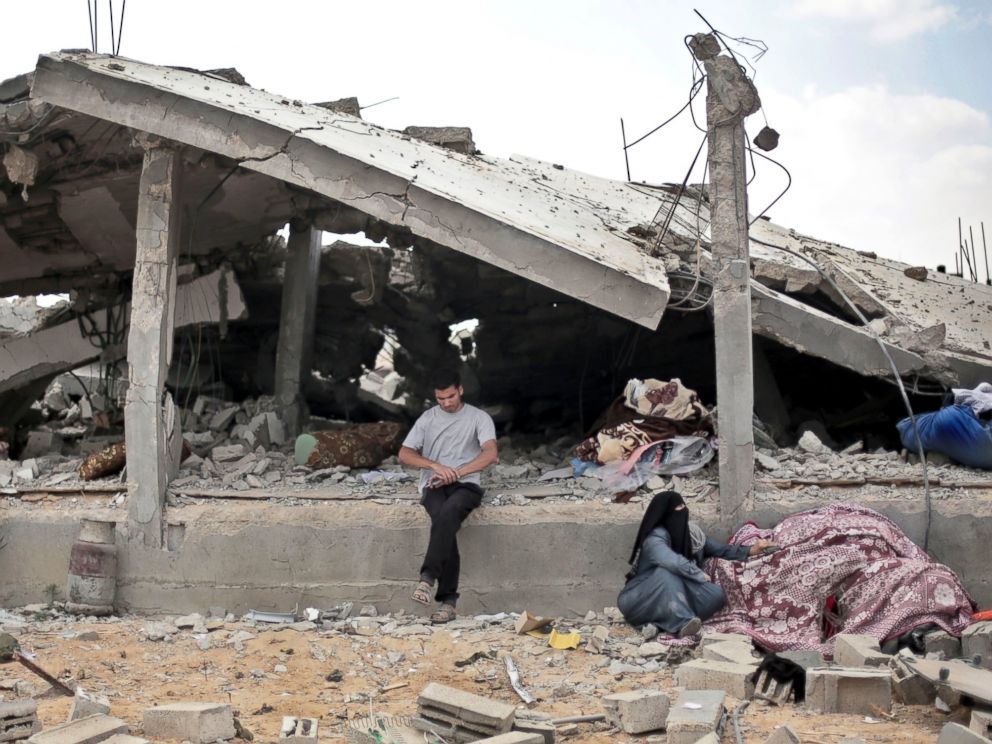 PHOTO: A Palestinian sits in front of a destroyed house in Rafahs district of Shawkah in the southern Gaza Strip, Aug. 5, 2014.