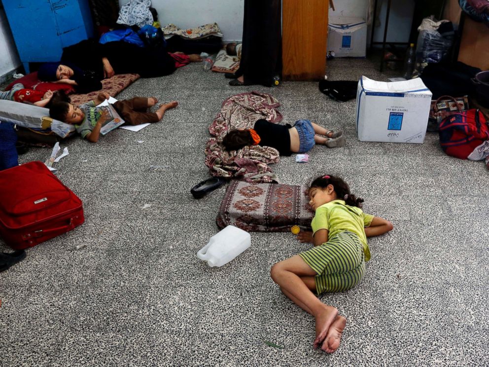PHOTO: Palestinian children lay on the floor at the Abu Hussein school in the Jebaliya refugee camp, northern Gaza Strip, on July 30, 2014.