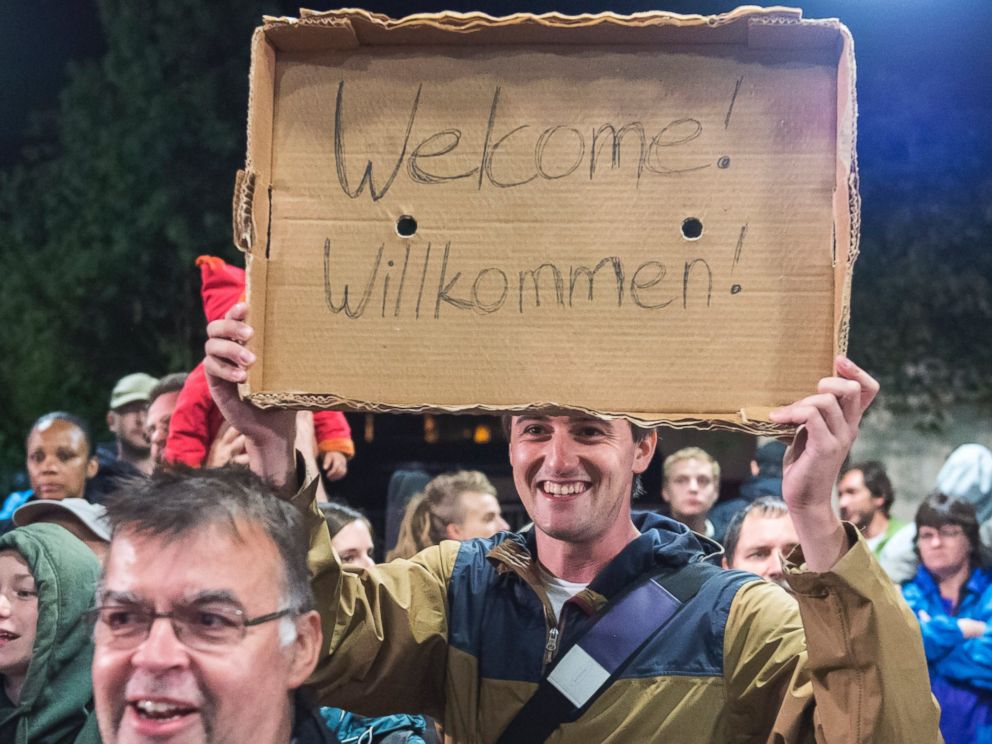 PHOTO: A man holds a Welcome sign for arriving refugees at the train station in Saalfeld, central Germany, Sept. 5, 2015.