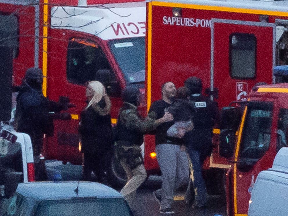 PHOTO: A security officer directs released hostages after they stormed a kosher market to end a hostage situation, Paris, Jan. 9, 2015.