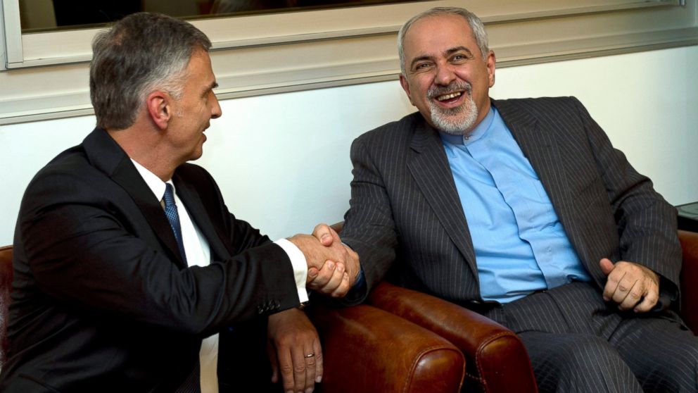 PHOTO: Switzerlands Foreign Minister Didier Burkhalter, left, shakes hands with Iranian Foreign Minister Mohammad-Javad Zarif, during a meeting at the Intercontinental Hotel.