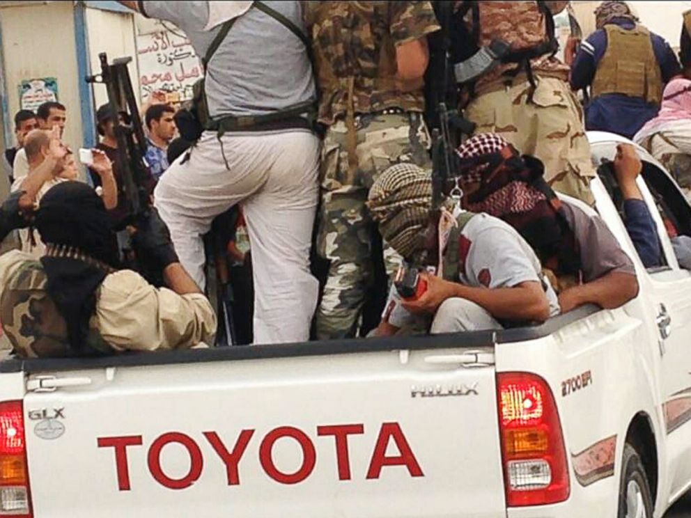 PHOTO: In this July 29, 2014 photo, Islamic militants parade in Beiji, Iraq.