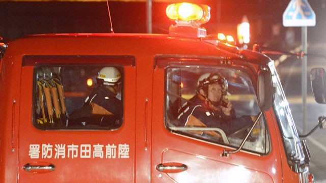 PHOTO: Firefighters in a fire fighting vehicle call for residents to evacuate from coastal areas in Rikuzentakata in Iwate Prefecture, Friday, Dec. 7, 2012, after a tsunami warning.