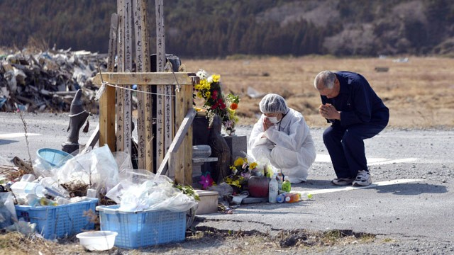 PHOTO: Residents pray in front of a memorial for the victims of the March 11, 2011 earthquake and tsunami as they make a brief visit to a caution zone in Namie, Fukushima prefecture, northern Japan Sunday, March 10, 2013.