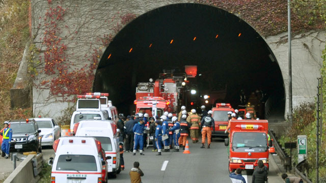 PHOTO: Police officers and firefighters gather at the exit of the Sasago Tunnel on the Chuo Expressway in Otsuki, Yamanashi Prefecture, central Japan, Sunday morning, Dec. 2, 2012.