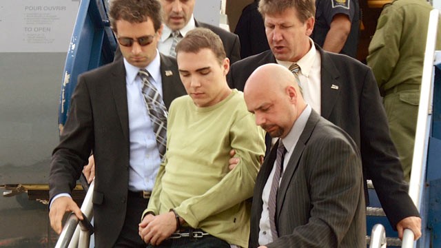 PHOTO: Luka Rocco Magnotta is taken by police from a Canadian military plane to a waiting van on Monday, June 18, 2012, in Mirabel, Quebec.