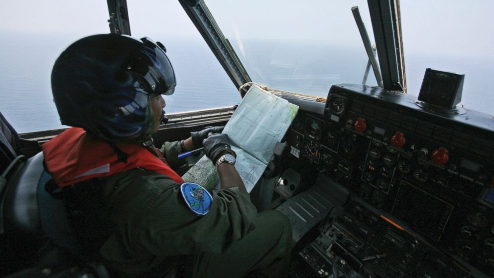 PHOTO: An Indonesian Navy pilot checks his map during a search operation for the missing Malaysian Airlines Boeing 777 over the waters bordering Indonesia, Malaysia and Thailand near the Malacca straits on March 10, 2014.