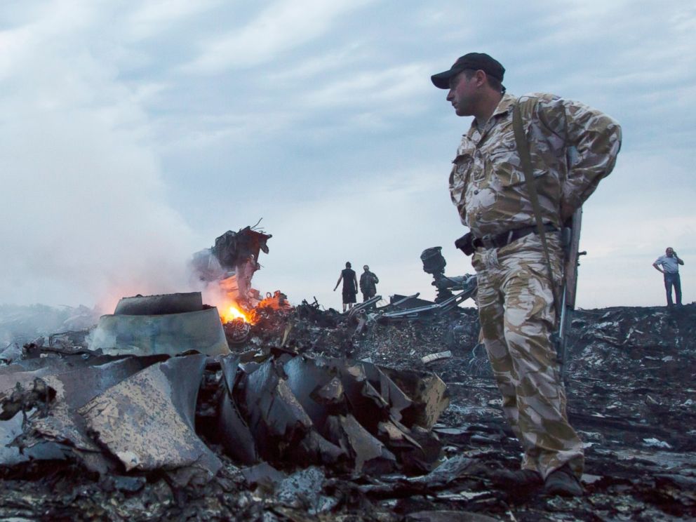 PHOTO: People walk amongst the debris, at the crash site of a passenger plane near the village of Grabovo, Ukraine, July 17, 2014.