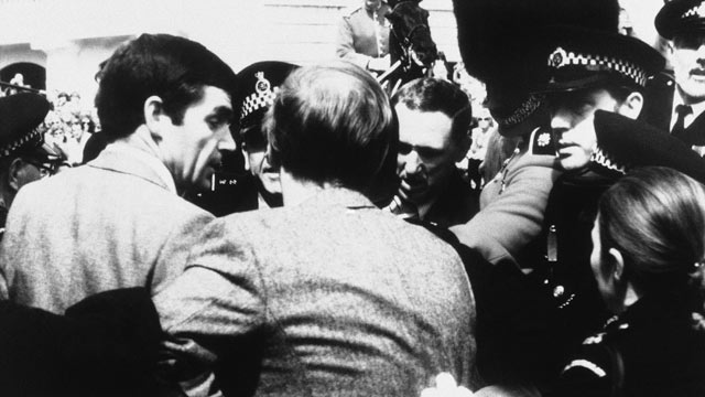 PHOTO: An army corporal (in bearskin) lends a hand to policemen arresting a man in the Mall, London, June 13, 1981, in connection with shots fired as the Queen Elizabeth rode passed on horseback to the Trooping the Color Ceremony. The man was later named 