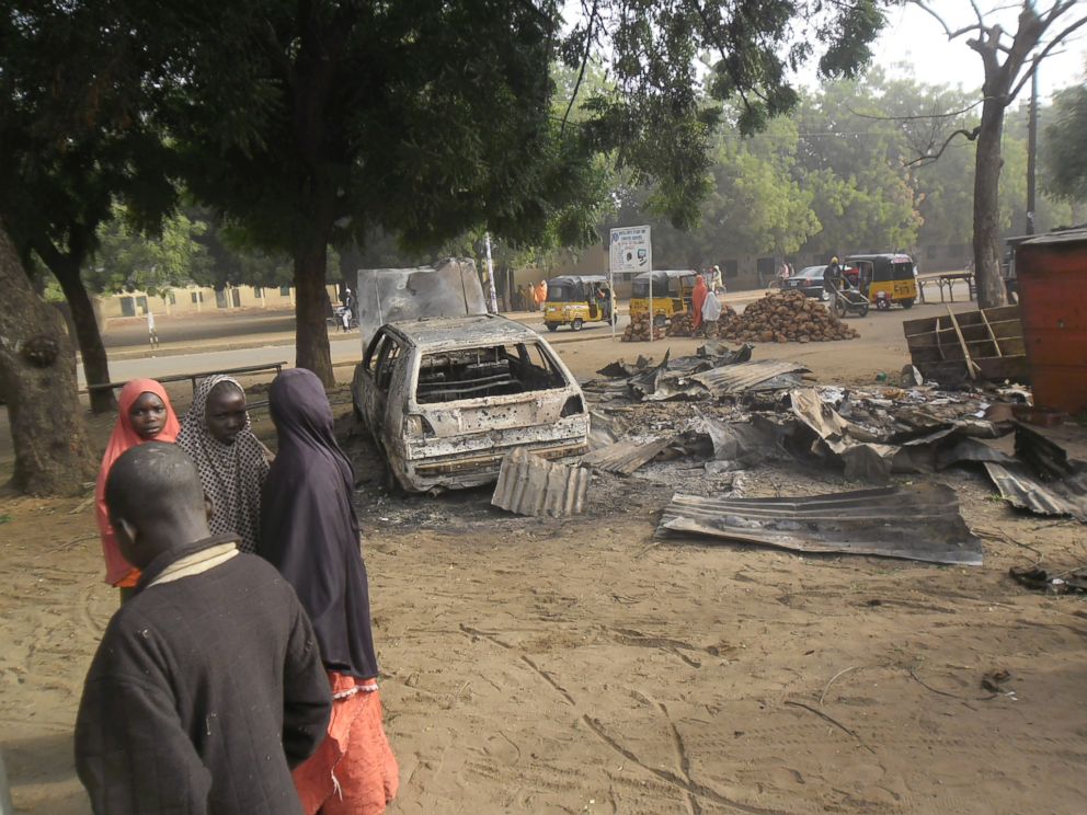 PHOTO: Children stand near the scene of an explosion in a mobile phone market in Potiskum, Nigeria, Jan. 12, 2015.