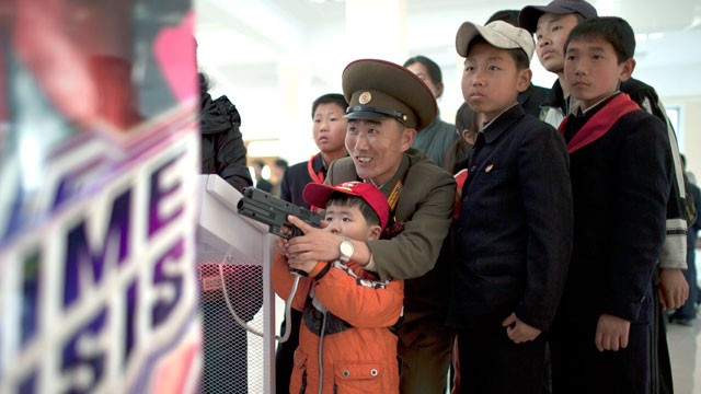 PHOTO: A North Korean military officer plays a game called "Time Crisis" with his son at an amusement park in Pyongyang, North Korea, April 16, 2013.
