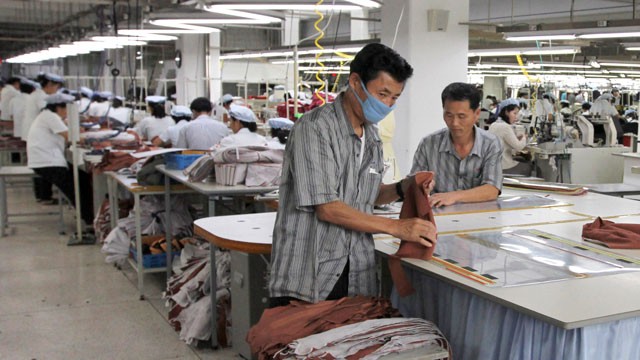 PHOTO: North Korean men are seen working for ShinWon, a South Korean clothing maker, preparing garments for production at a factory in Kaesong, North Korea, Sept. 21, 2012.