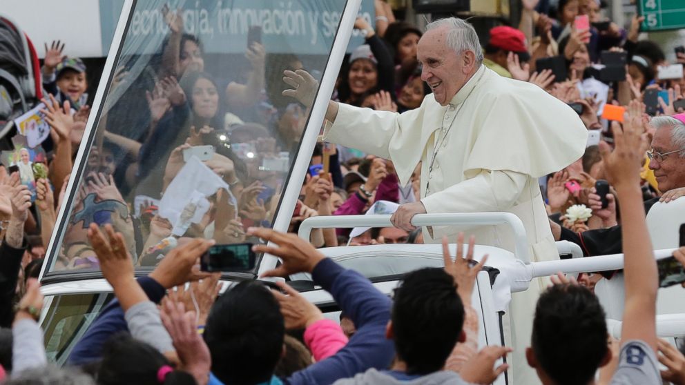 PHOTO: Pope Francis waves to the crowd as he rides aboard the Popemobile in the streets of Quito, Ecuador, Sunday, July 5, 2015.